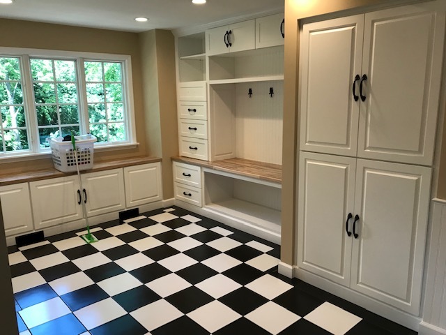 black and white floor tile with white cabinets